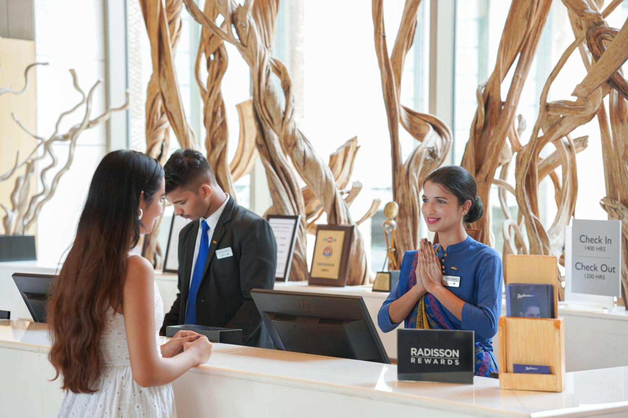 Radisson Blu Hotel Amritsar Esterno foto A hotel receptionist at work