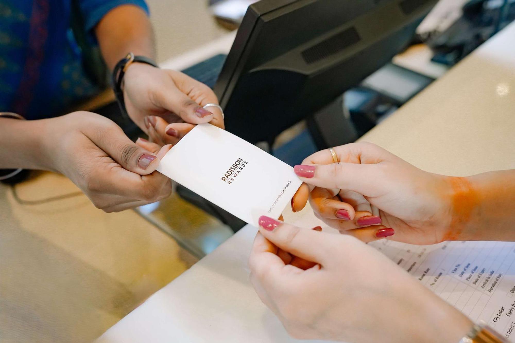 Radisson Blu Hotel Amritsar Esterno foto A person's identity is verified with a passport at a border crossing.